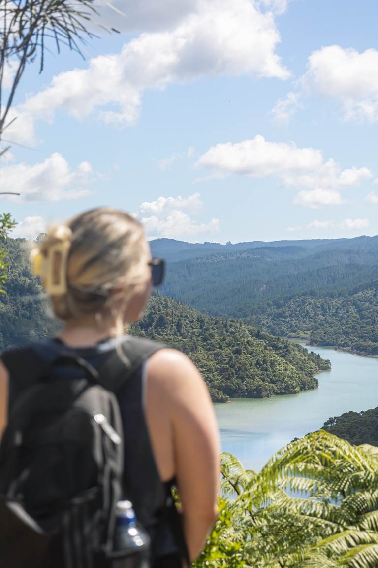 Girl standing in front of Auckland lookout over Wairoa Reservoir