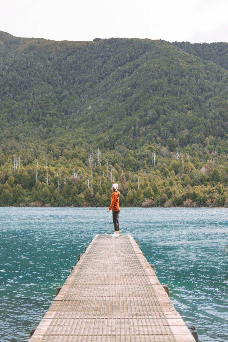 girl standing on wharf in queenstown during winter