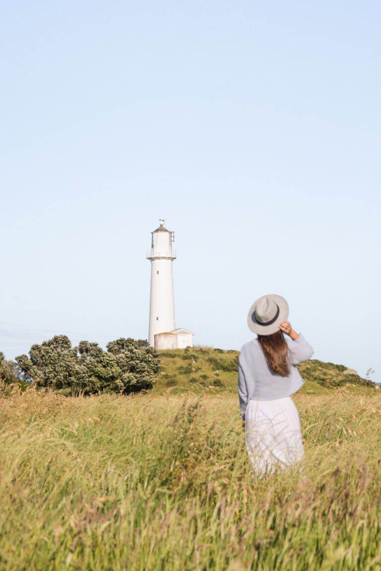 girl standing in front of egmont lighthouse