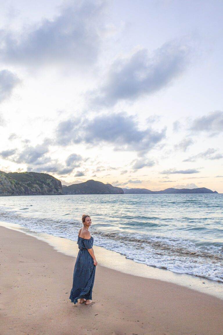 girl standing at tauranga bay, northland, new zealand in summer