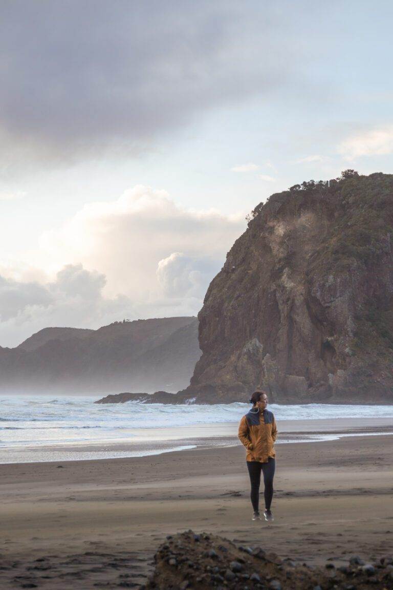 girl standing at piha beach