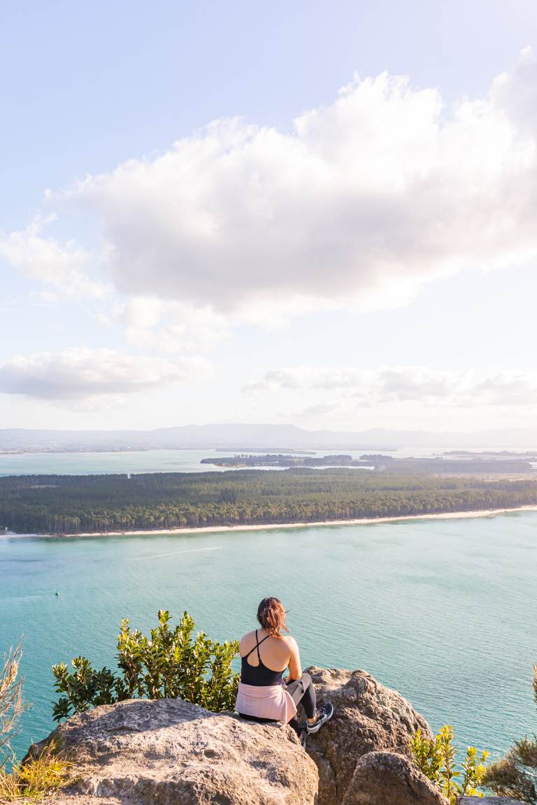 girl sitting at lookout Mount Maunganui New Zealand