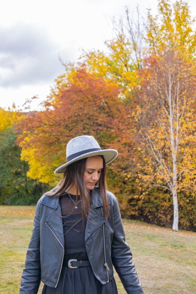 woman with autumn trees in background – About page