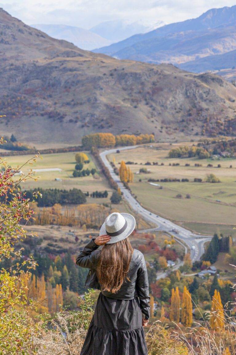 woman standing in front of arrow junction lookout