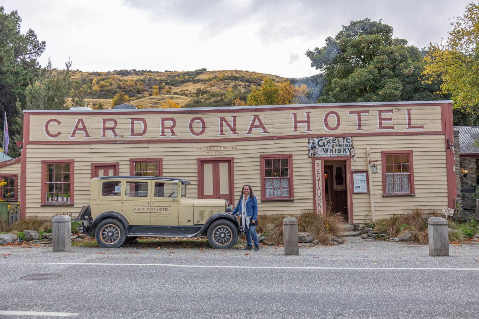 woman standing in front of cardrona hotel