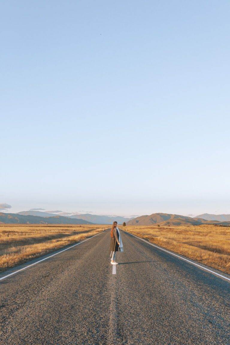 woman standing in landscape on state highway 8, south island