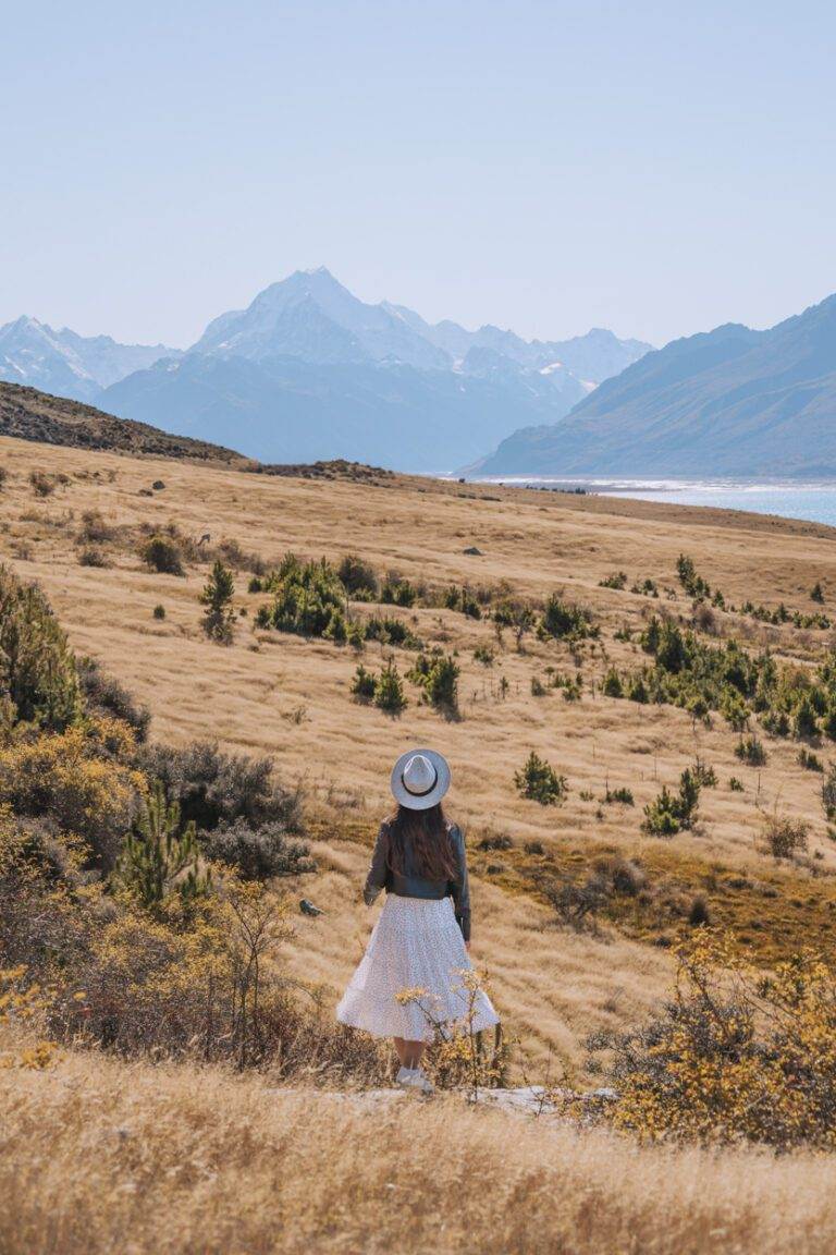 South Island landscape photography of woman standing in front of mount cook