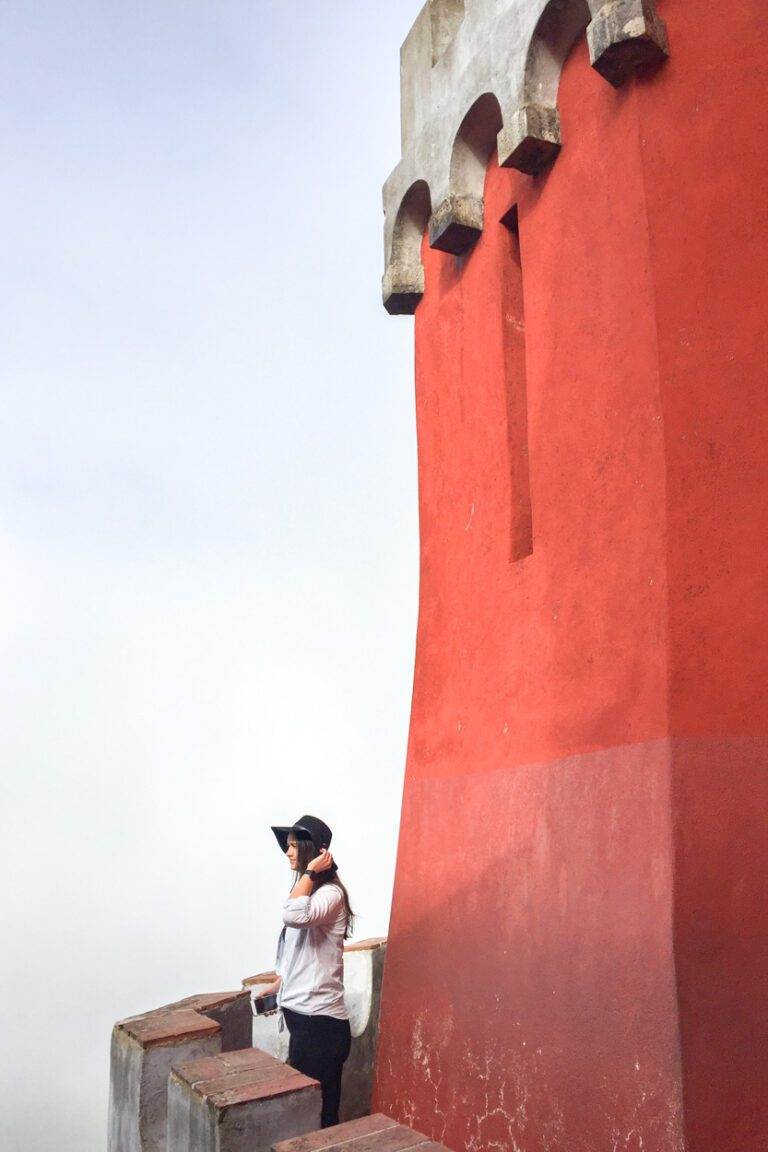 girl standing outside pena palace red castle