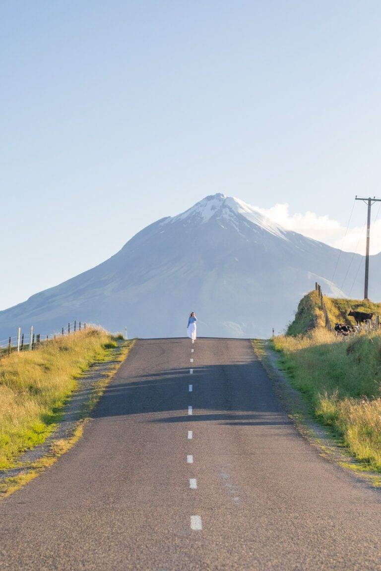 girl walking at sunrise along arawhata road New Zealand landscape photos