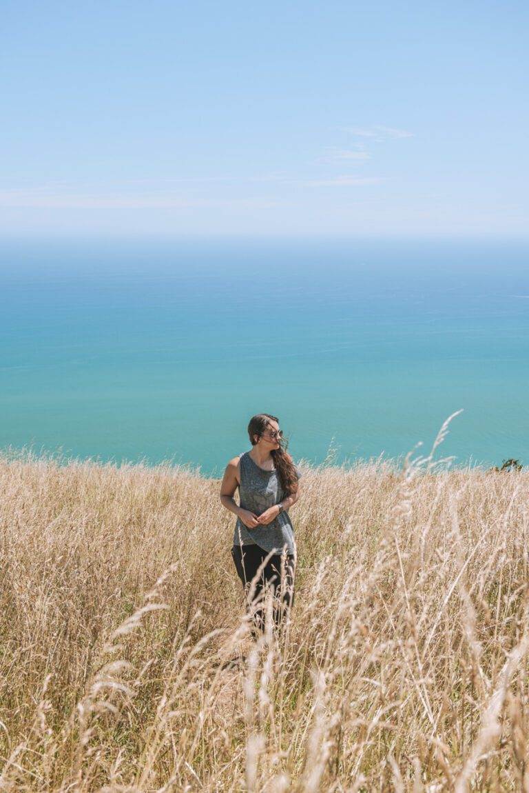 girl standing on mount karioi after hiking north island new zealand