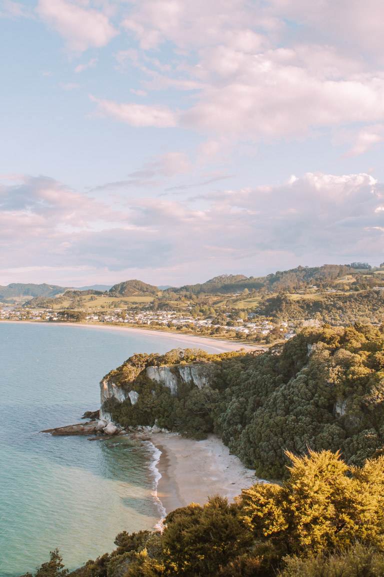 looking over lonely bay beach at sunset