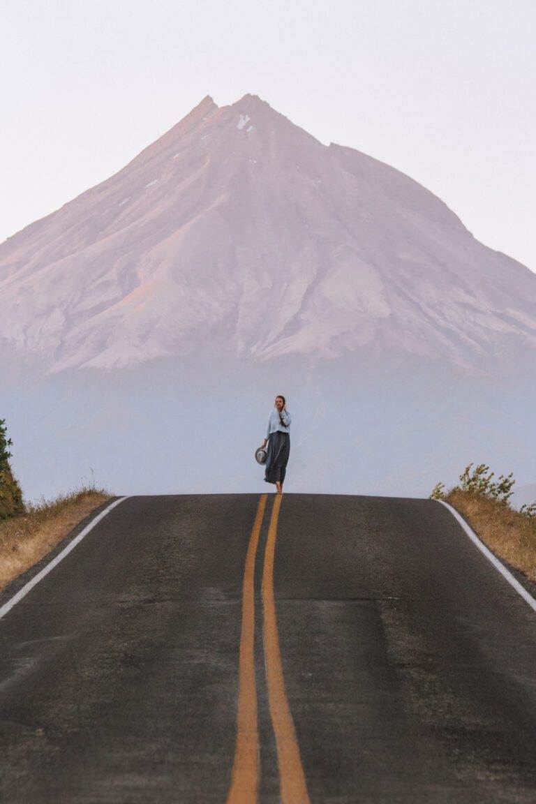 girl standing at the top of kent road with mount taranaki in the background