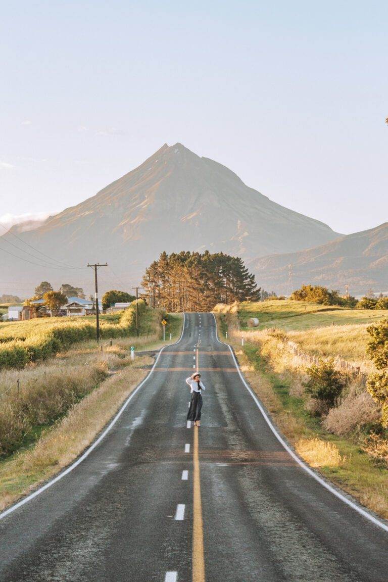 girl walking at sunrise along New Zealand landscape photos at kent road