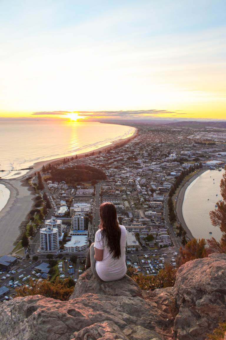 girl sitting on top of Mount Maunganui New Zealand