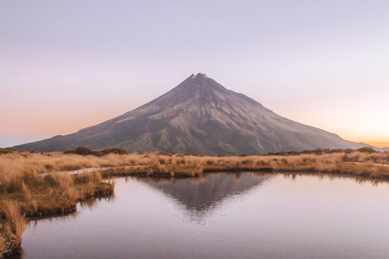 landscape of mount taranaki and pouakai tarns at sunset