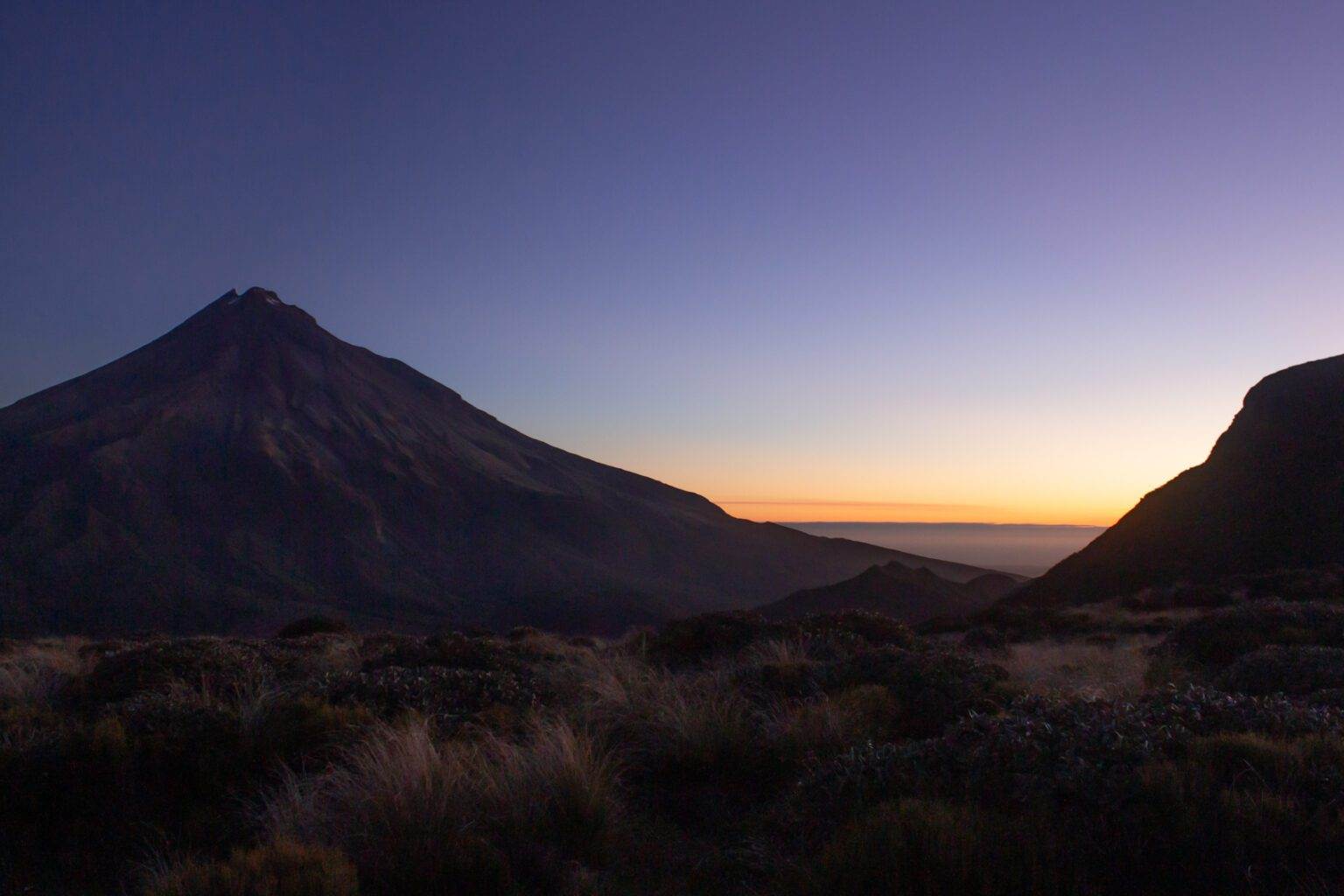 sunset of mount taranaki from pouakai tarns trail