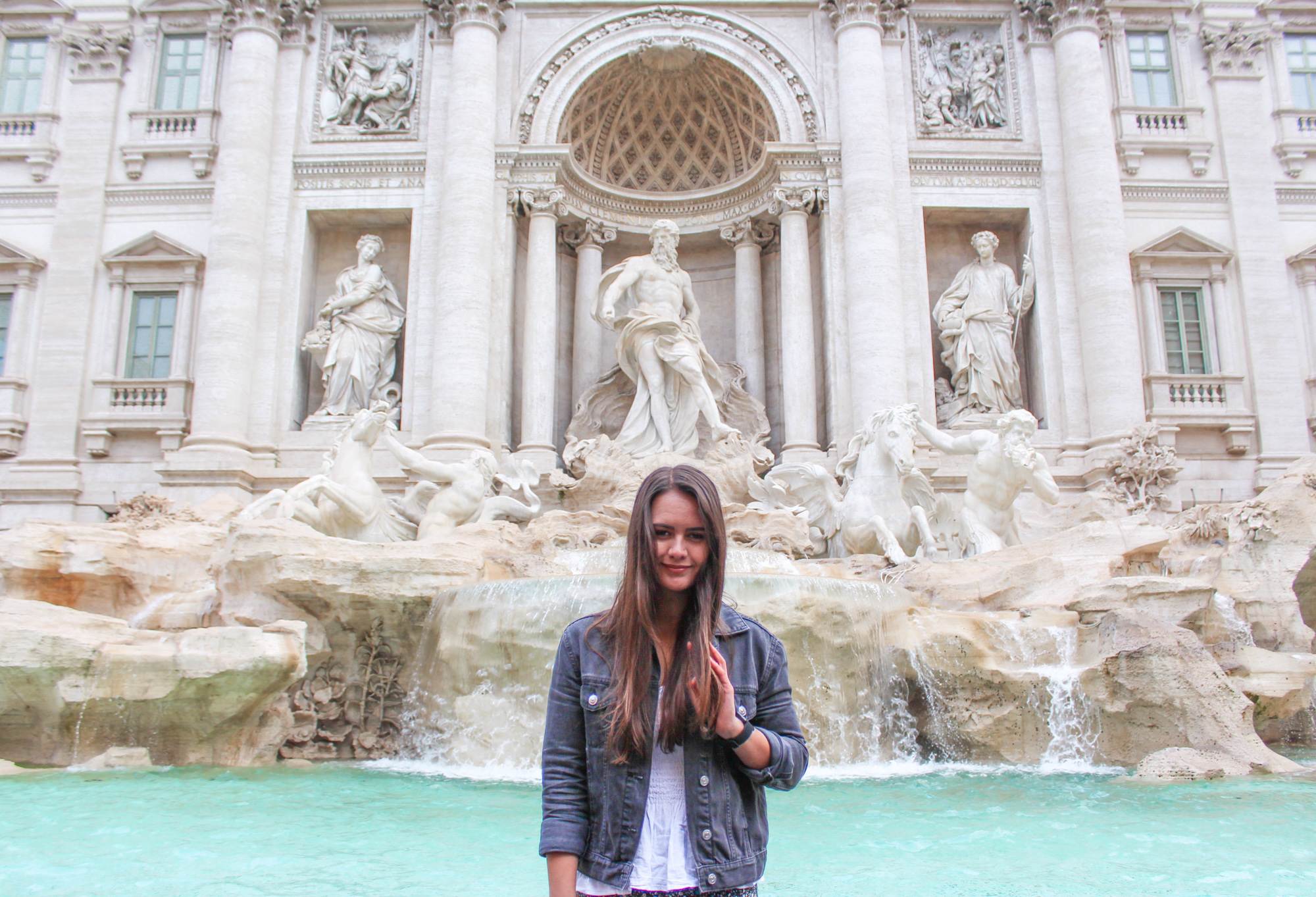 girl standing in front of trevi fountain