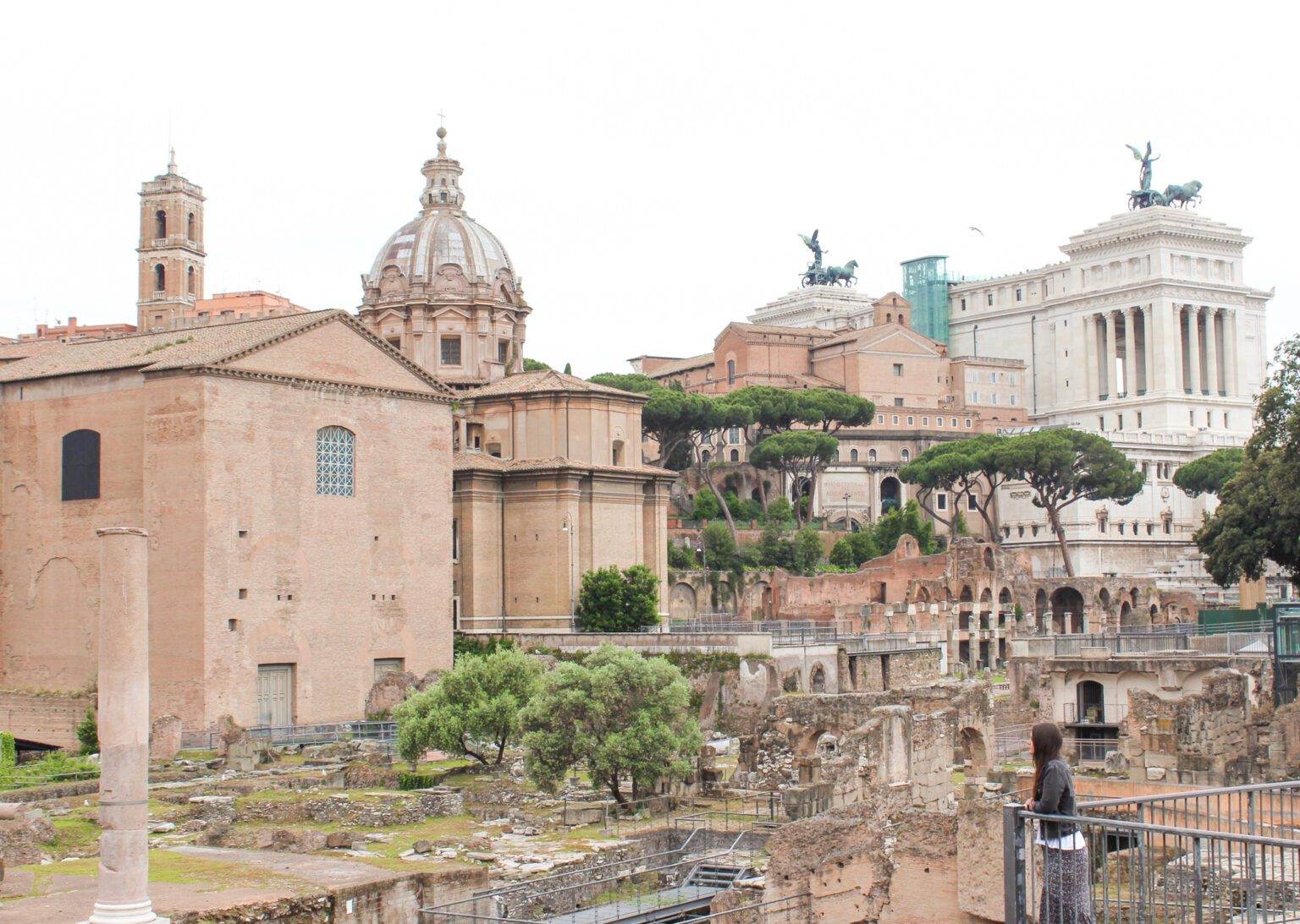 girl standing among the roman forum in rome