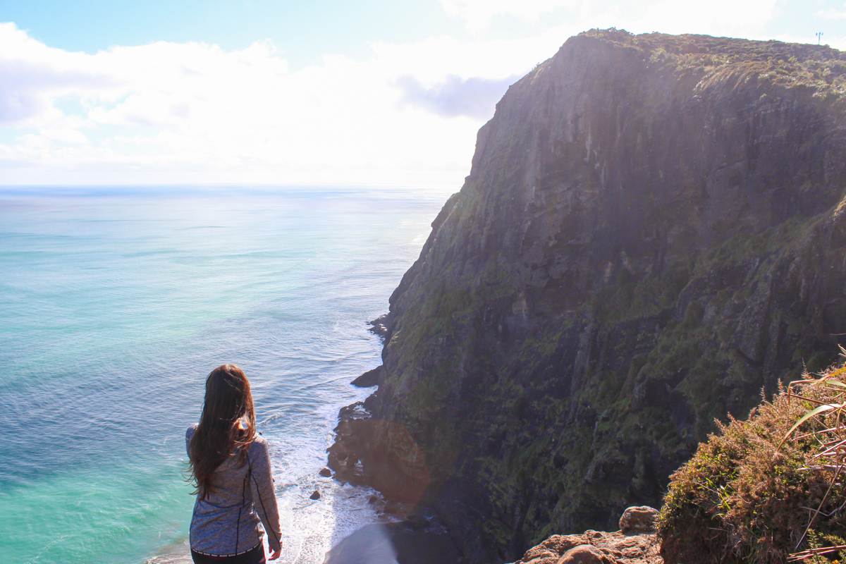 girl looking over view of mercer bay loop trail west coast auckland New Zealand landscape photos