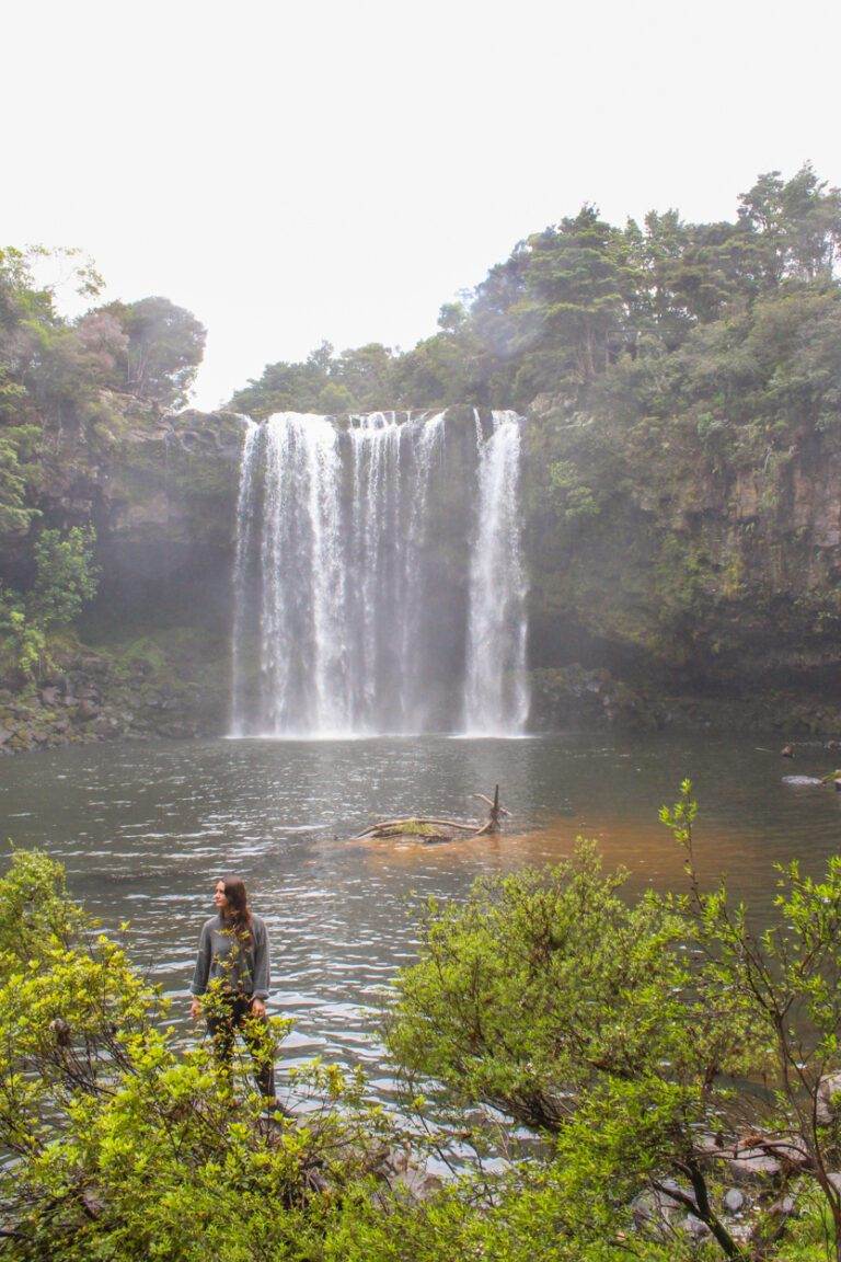 girl standing at base of rainbow falls