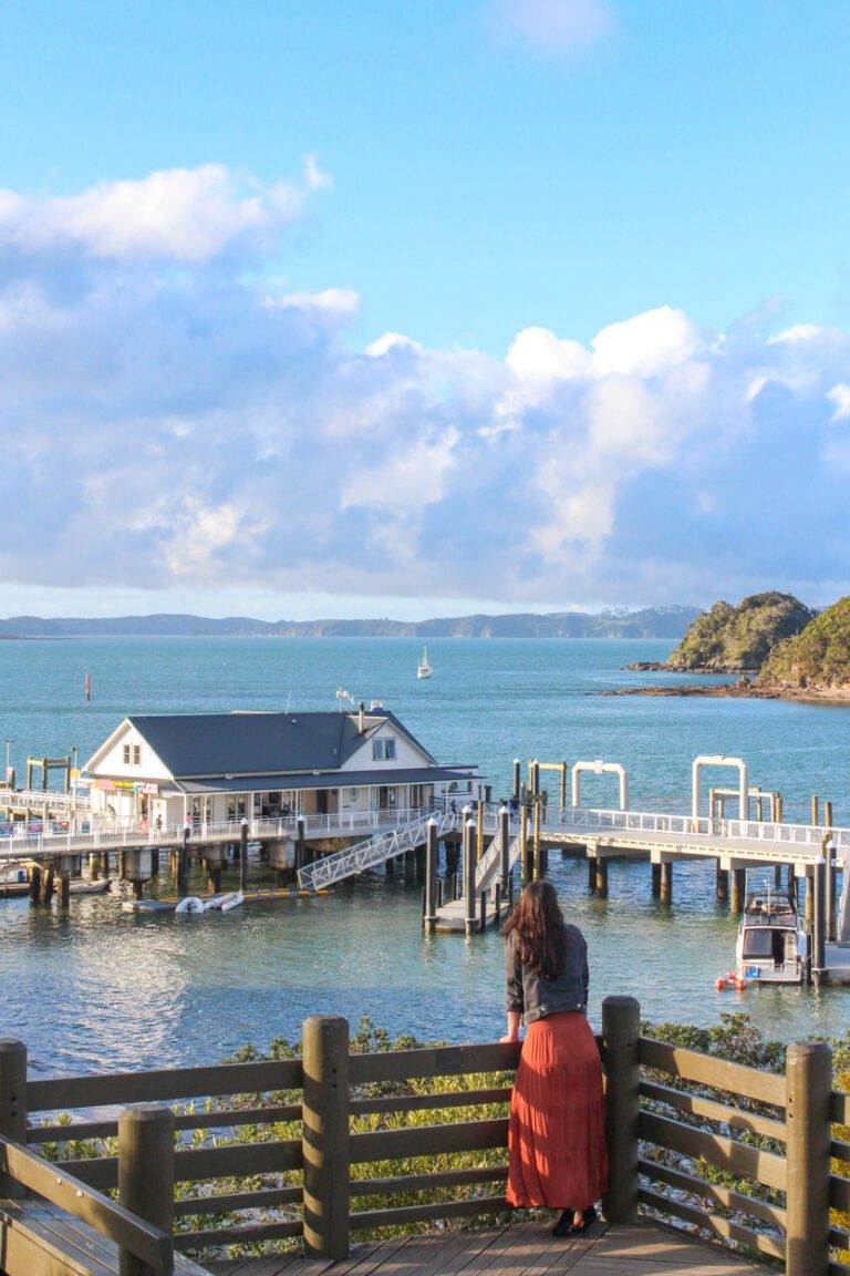 girl standing overlooking paihia wharf