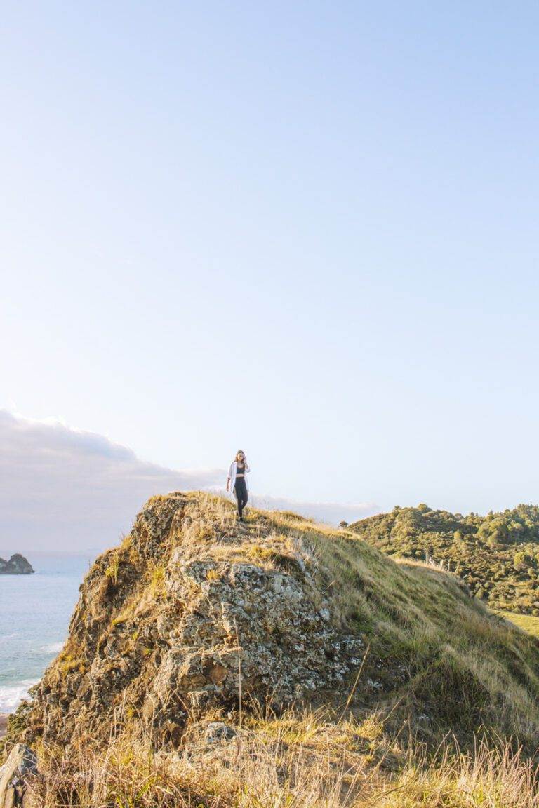 girl walking down opito bay pā