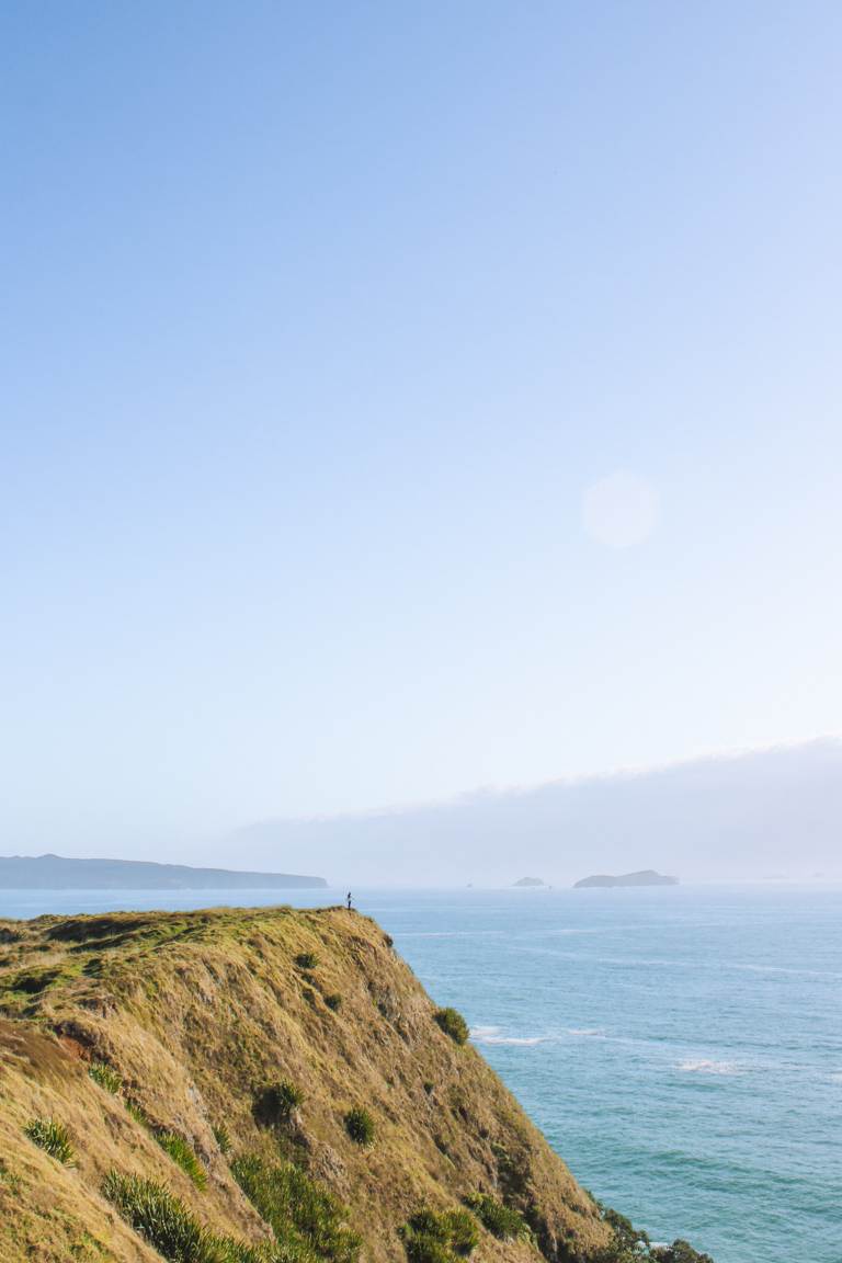 girl standing at Opito Bay Pā headlands