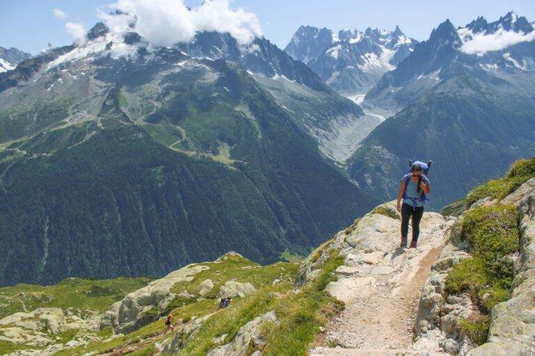 essential photography gear for hiking girl hiking with mountain landscape