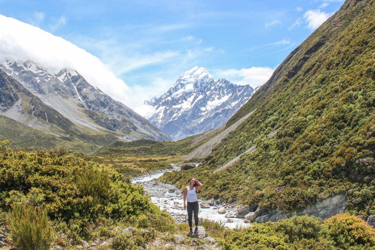 image of girl with mount cook in background hooker valley track in New Zealand landscape photos