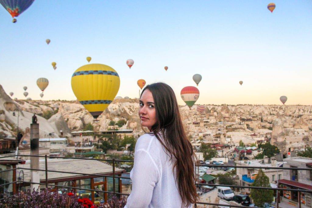 girl standing on balcony at artemis caves cappadocia