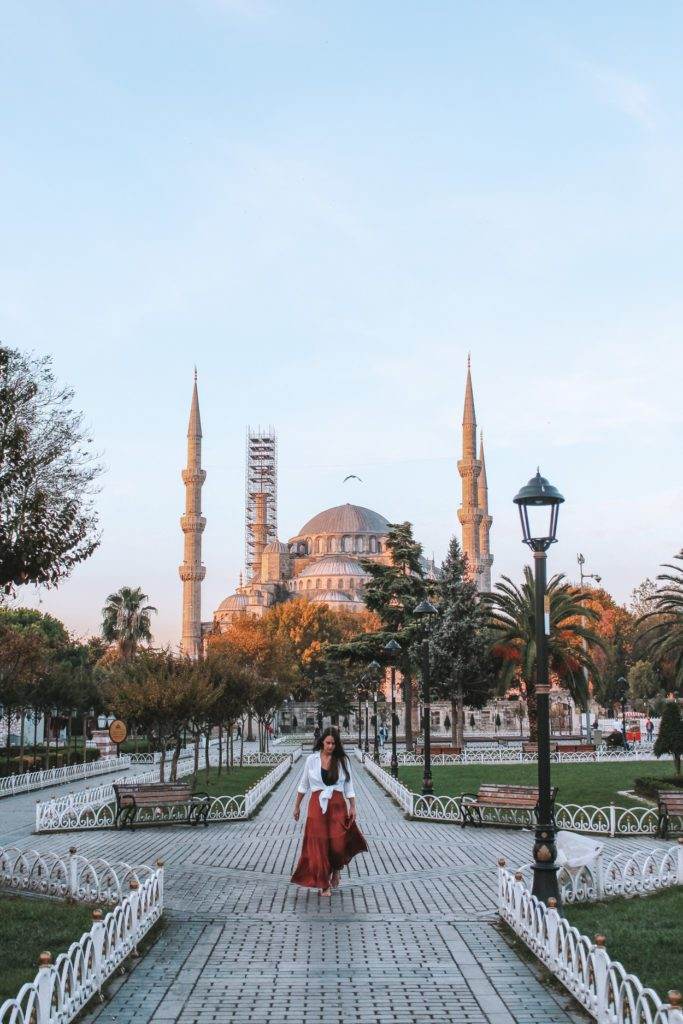 girl walking in the blue mosque garden