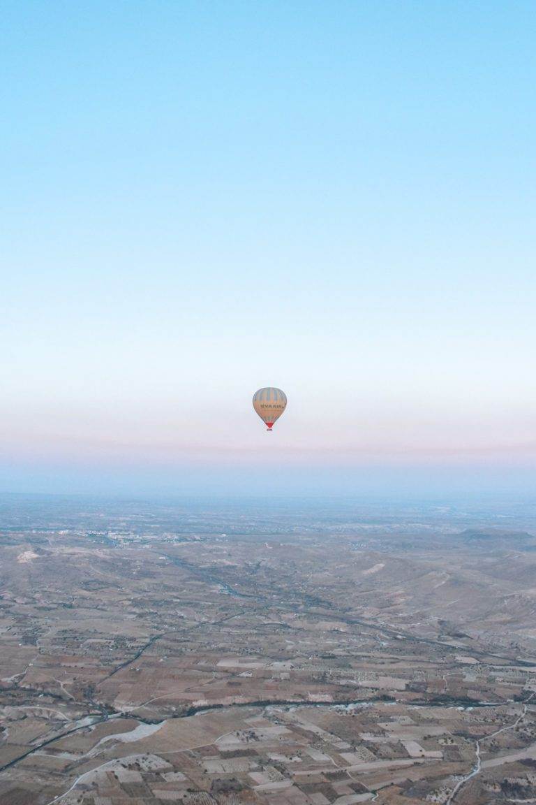 single hot air balloon at sunrise cappadocia