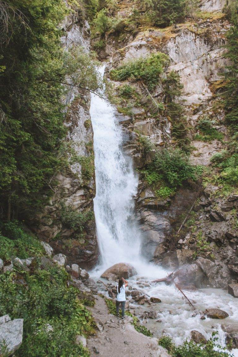 standing at cascade du dard waterfall base