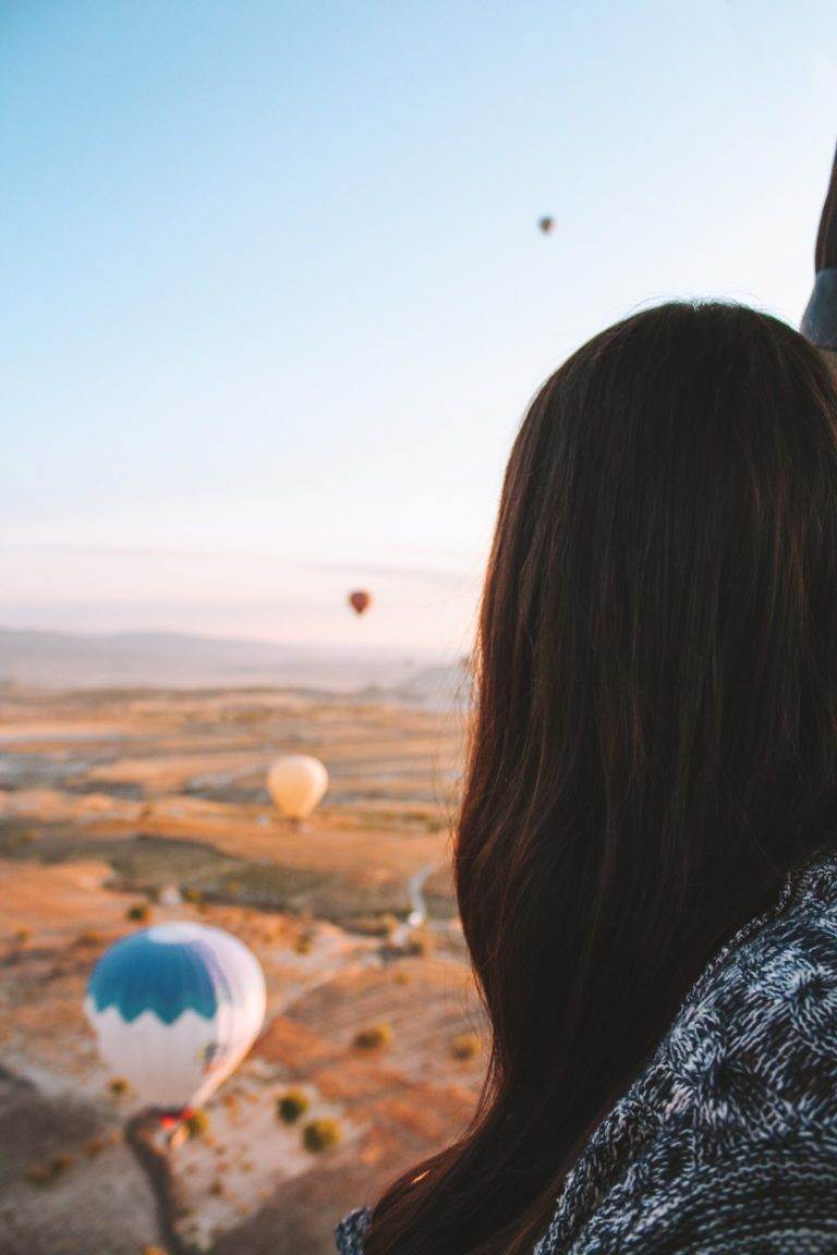 girl looking out of hot air balloon