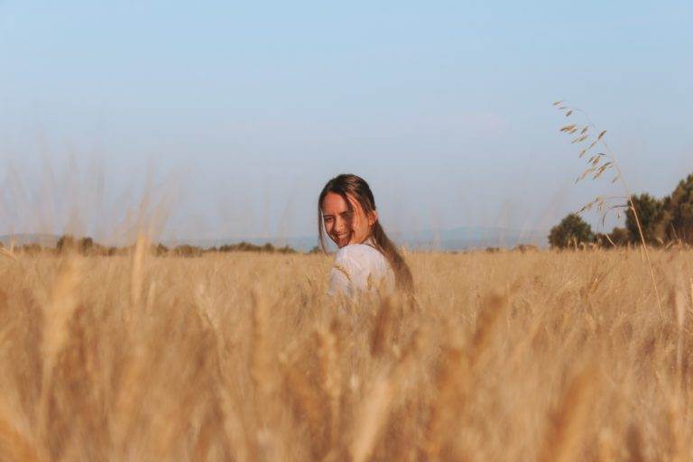 girl sitting in wheat field