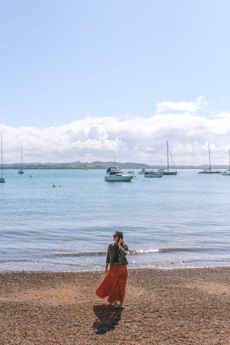 northland road-trip girl standing on russell beach