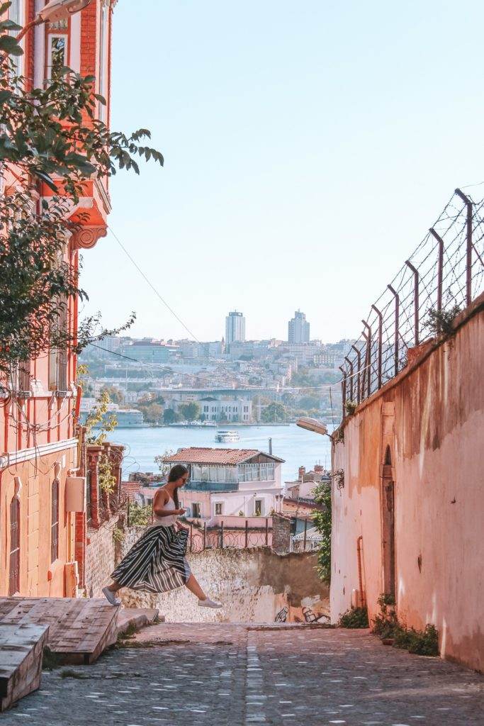 girl jumping with background of istanbul